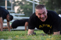 Army Reserve command sergeant major performs plank.