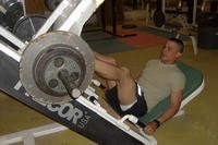 Soldier works on leg-press machine.