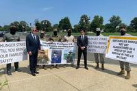 Rep. Michael McCaul and Parker Young pose with U.S. troops