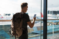 Solider in Airport Walking and Talking on Phone