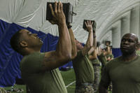 Marine recruiters perform ammunition can lifts.