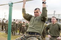 A Marine does a pull-up as part of a Frozen Chosin competition in Japan.