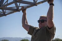 An airman performs a pull-up.