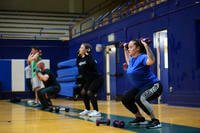 Sailors perform dumbbell squats.