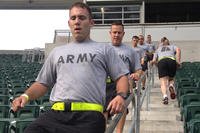 Soldiers run stadium steps.