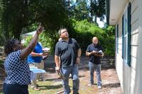 Student inspectors examine a cottage for structural damage