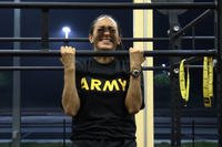 An Army major performs a flexed arm hang.