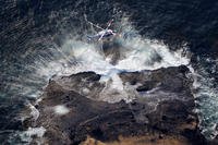 A rescuer being lifted in a search operation for missing passengers of a sunken tour boat in Japan. 