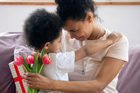 Mother with child and flowers and gift