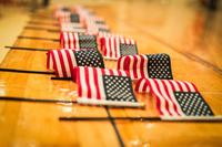 U.S. flags are presented during a naturalization ceremony.