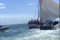 Coast Guard rescue crews safely transfer people from a grounded vessel to U.S. Coast Guard ships.