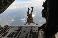 U.S. Air Force pararescueman exits the back of a C-130J Super Hercules.