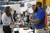 A job seeker networks at a job fair.