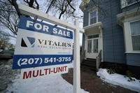 A sign announces a home for sale on Munjoy Hill in Portland, Maine.