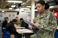 A sailor reads Navy-Wide Advancement Exam instructions.