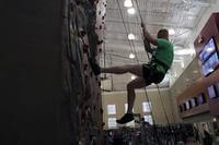 A Marine belays down the rock wall.