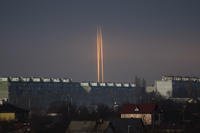 Three rockets launched against Ukraine from Russia's Belgorod region are seen at dawn in Kharkiv