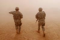 Two soldiers patrol in Iraq during Operation Iraqi Freedom.