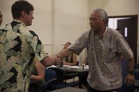 Christopher Sereno, the manager of the Marina and Outdoor Recreation and Equipment Center and Five-O Motors, meets a potential employee during a Marine Corps Community Services job fair aboard Marine Corps Base Hawaii.