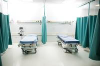 two empty beds in an emergency room