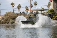 U.S. Marines with Charlie Company, 3d Assault Amphibian Battalion, 1st Marine Division, launch an amphibious combat vehicle into the water