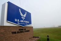 Heavy fog covers a sign at the front of the entrance at Minot Air Force Base.