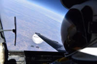 In this image released by the Department of Defense on Wednesday, Feb. 22, 2023, a U.S. Air Force U-2 pilot looks down at a suspected Chinese surveillance balloon as it hovers over the United States.