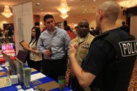 An IRS criminal investigator speaks to Marines, sailors and families about job opportunities as a special agent during a Hiring Heroes Career Fair at Camp Pendleton.