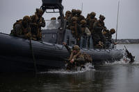 U.S. Marines disembark small boats in preparation for a simulated raid as part of MEU Exercise III on Camp Lejeune, North Carolina.