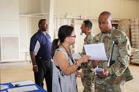 An administrative assistant with Naval Supply Systems Command Fleet Logistics Center Pearl Harbor discusses veteran’s preference with a service member during a 'Hiring Our Heroes' transition summit at Schofield Barracks.
