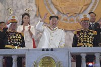 North Korean leader Kim Jong Un, center, watches a military parade