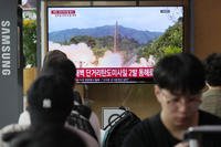 TV screen shows a file image of North Korea's missile launch