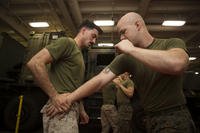 U.S. Marine Cpl. Aaron Spaulding and Cpl. Nathaniel Hubbard practice Marine Corps Martial Arts Program techniques.