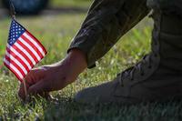 Airman places a flag in remembrance of troops who were lost to suicide