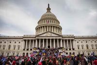 Pro-Trump protesters stand on the East steps of the Capitol Building