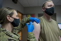 Staff Sgt. Caroline M. Schmauch administers the second dose of the COVID-19 vaccine to an airman at the Pittsburgh International Airport Air Reserve Station, Pennsylvania.