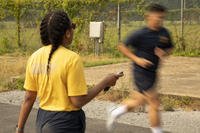 Hospital Corpsman 1st Class Adirachel Sauvou, Naval Medical Research Command (NMRC)’s command fitness leader, marks time and encourages a sailor during the annual physical readiness test.