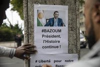 Demonstrators gather in front of the Embassy of Niger in Paris