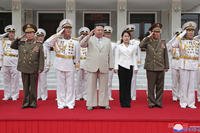 North Korean leader Kim Jong Un, center, with his daughter, center right, reportedly named Ju Ae