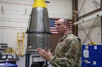 Chief Master Sgt. Andrew Zahm speaks in front of a Minuteman III intercontinental ballistic missile