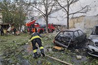 emergency services personnel work to extinguish a fire following a Russian attack in Cherkasy
