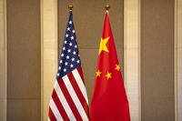 United States and Chinese flags are set up before a meeting