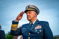 Adm. Karl Schultz, the 26th Commandant of the Coast Guard, salutes during the 34th Annual Candlelight Vigil