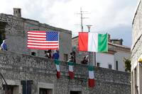 A United States flag and Italian flags hang in Pacentro, Italy