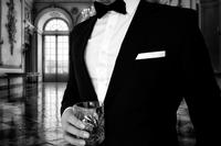 man with drink in tuxedo