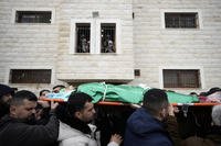Palestinian mourners carry the body of Muhammad Jalamneh, draped in the Hamas militant group flag