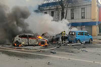 firefighters extinguish burning cars after shelling in Belgorod, Russia