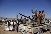 Houthi fighters and tribesmen stage a rally against the U.S. and the U.K. strikes on Houthi-run military sites