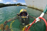 Navy Diver 1st Class Jason Bumpass waits on the water’s surface before going to work in Victoria, Seychelles.