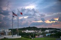 The American and Japanese flags flying just before sunset at U.S. Marine Corp Base Camp Foster